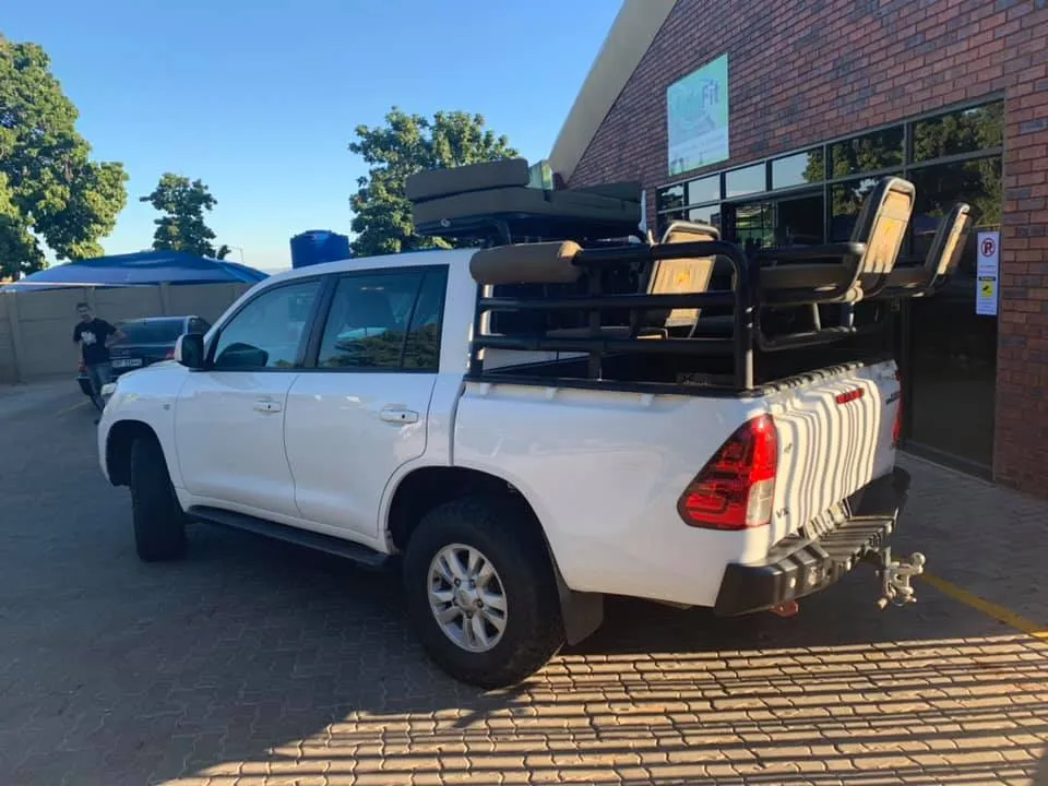 Toyota Land Cruiser 200 double cab bakkie conversion fitted with a custom steel game viewing frame, rear seating, and heavy-duty steel rear bumper.