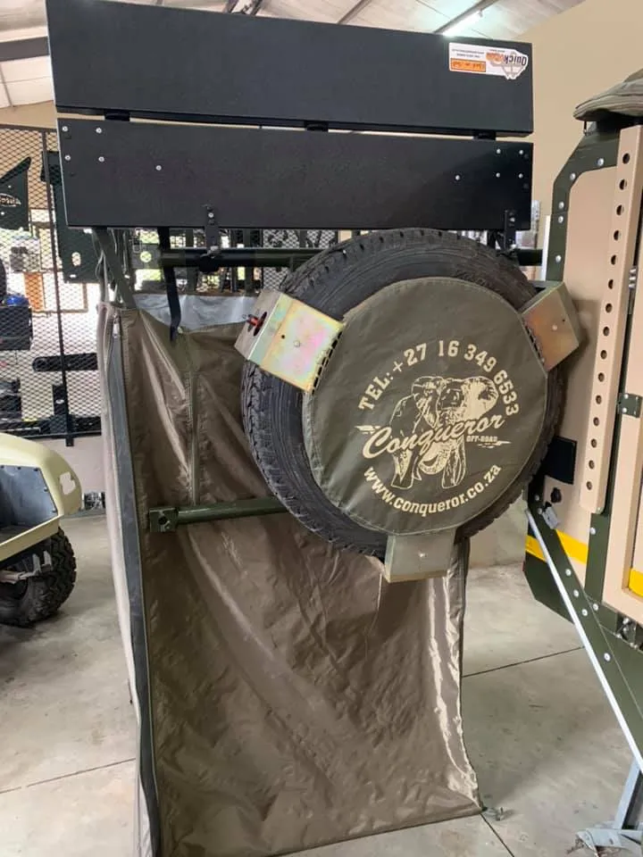 Quick Pitch Ensuite shower tent mounted above the spare wheel of an off-road camping trailer