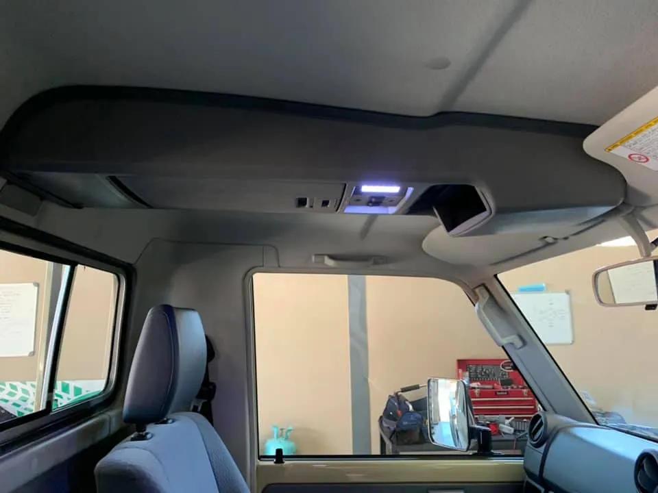 Outback overhead roof console with integrated LED map lights and storage slot fitted in a Toyota Land Cruiser cab