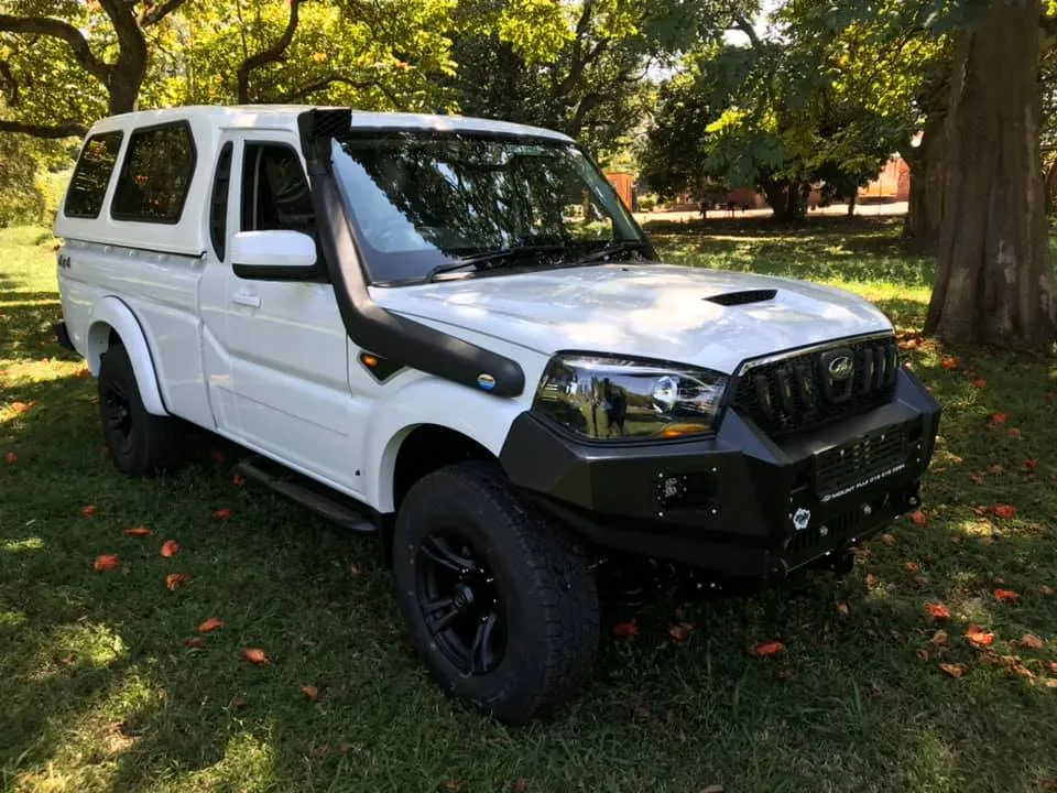 White Mahindra Pik-Up single cab fitted with a heavy-duty steel front bumper, off-road snorkel, and canopy