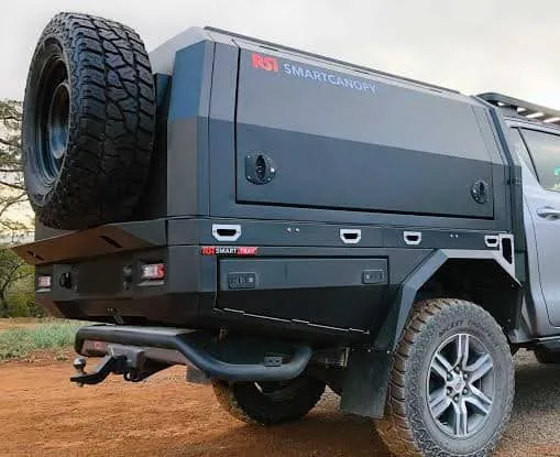 Grey Toyota Hilux double-cab fitted with a matte black steel RSI SmartTray and matching RSI SmartCanopy with spare wheel carrier