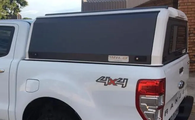 White Ford Ranger double-cab fitted with a dual-tone white and black Wild Access canopy